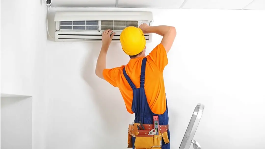 Un technicien travaillant sur l'entretien d'une climatisation