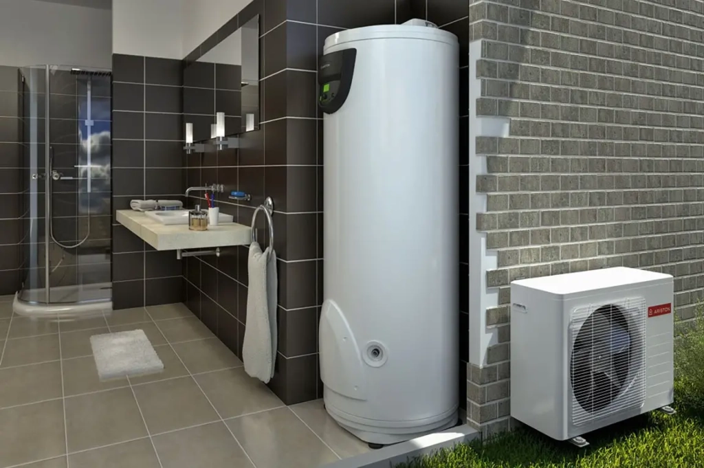 La salle de bains moderne est équipée d'un grand chauffe-eau blanc et d'un radiateur compact, le tout entouré de murs carrelés foncés et d'une douche. L'ambiance est élégante et fonctionnelle.